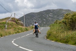 Young female traveler cyclist smiling on Connemara route Galway Ireland