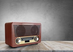 Old brown radio, retro radio on wooden table. Perspective vintage radio.