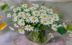 started embroidery of daisies with beads. bags with multi-colored beads for embroidery of pictures. Preparation for embroidery, selection of beads, hobbies. soft focus