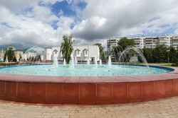 Fountain with gushing jets of water in Belgorod against the background of the spring urban landscape. The concept of travel in Russia