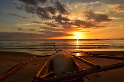 Filipino fishing boat at sunset on the sugar beach, Fishing boat on the beautiful sandy coast of the negros island