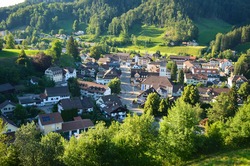 view of the small village of bauma in the toesstal in zurich oberland. Surrounded with a lot of hills and forests. Swiss