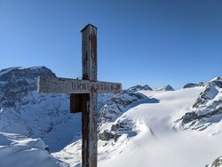 summit cross on the Gemsfairenstock and in the background the Piz Russein. Day of ski touring in the Glarner Alps.