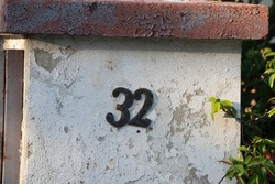 Number 32( thirty two) on wall, house number
