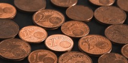 Euro cent coins on table close up. Abstract background from coins. Soft focus.
