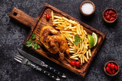 Half roasted chicken Piri Piri with french fries, top view