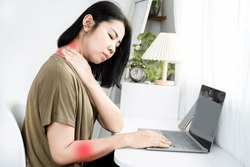 Cervical Radiculopathy (Pinched Nerve) concept with Asian woman suffering from neck and shoulder pain radiating down the arm from long-term computer use 