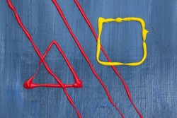 A red triangle with three slanted lines and a yellow square on a blue glossy background.