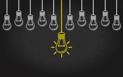 Light bulbs on a blackboard background. Creativity concept with innovation or inspiration in business, thinking outside the box.Strategy and leadership on teamwork. Opportunity, solution and success.