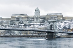 the Buda castle and the Chain Bridge above the Danube river in Budapest, Hungary in winter