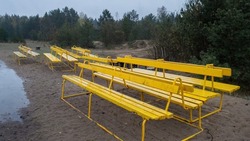 Summer beach benches grouped in a cluster. Yellow public outdoor benches