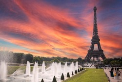 Eiffel Tower of Paris from the Trocadero gardens and with the fields of Mars of the French capital in the background next to the Seine River and under a beautiful sky monument is the iconic symbol.