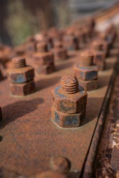 Close-up of old, rusted fixing screws.