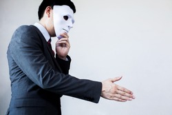Business man giving dishonest handshake hiding in the mask - Business fraud and hypocrite agreement.
