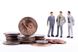 1 American dollar coin, other coins on a white background and three figurines of symbolic businessmen