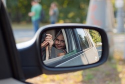 The concept of auto travel. The family travels by car. image in the car mirror