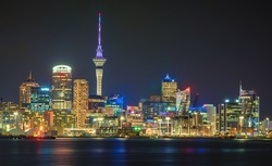 Auckland city skyline at night with city center and Auckland Sky Tower, the iconic landmark of Auckland, New Zealand.