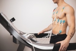 A young athlete undergoes a stress test on a treadmill.It measures the activity of the heart with an electrocardiogram.
