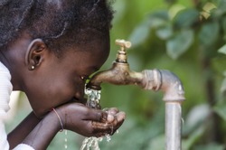 Clean Fresh Water Scarcity Symbol: Black Girl Drinking from Tap.

Young African girl drinking clean water from a tap. Hands with water pouring from a tap in the streets of the city Bamako, Mali.