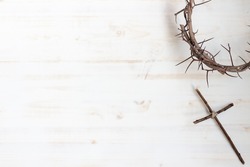 Crown of thorns with wood cross on white background with copy space