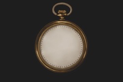 Timeless concept. Antique clock without numbers and hands, isolated on black background. Photomanipulation.