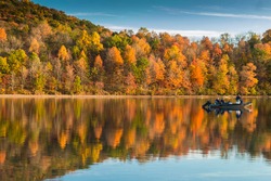reflection of the peak autumn foliage in Lake Habeeb in Rocky gap State Park in Maryland