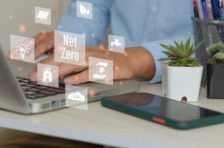 man hand using laptop to working technology and business concept.NET ZERO icons and symbols save the eco world and reduce pollution virtual screen.