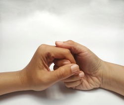 Couple holding hands, Close up of two hands isolated on white background