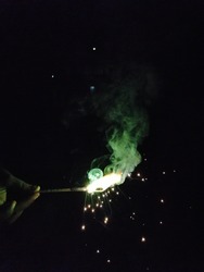 Sparkling green color crackers in black background