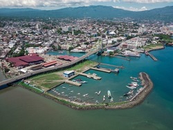 Manado City, North Sulawesi Province, Indonesia. view from above with boat harbor and landmark of the sukarno bridge.