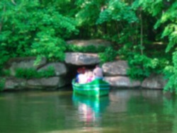 Blurred photo. Tourists in a boat swim into the cave.