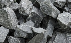 Close up of a pile of large crushed granite stones, to sell as building material