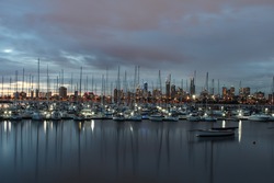 St Kilda Beach - Clam waters - Boats parked and view of Melbourne city - Sunset
