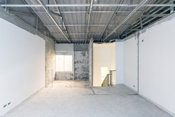 Construction site of empty Interior space, unfinished building after demolition process. Home improvement and renovation business.