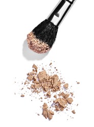 close up of  a make up powder and a brush on white background