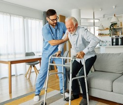 Doctor or nurse caregiver with senior man using walker assistanece  at home or nursing home