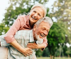 Happy active senior couple having fun outdoors. Portrait of an elderly couple together