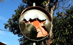 Broken traffic mirror. Traffic mirrors reflecting road junctions and traffic signs No Entry. 		