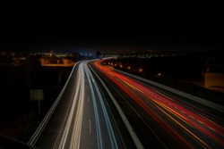 Speed lights on the road with long exposure.
List of cities and towns at the background: Barcelona, Platja d'Aro, Calonge, Sant Antoni de Calonge, Palamós.