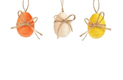 Three colorful easter eggs hanging on a white background