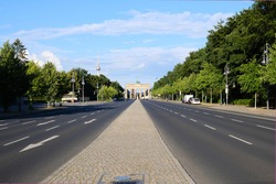 Berlin, Germany, view over the Strasse des 17. Juni to the world famous Brandenburg Gate and the TV Tower at Alexanderplatz in the background  