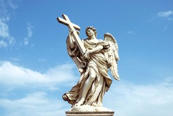 sculpture angel suggesting a cross with a roman blue sky