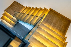 Modern illuminated wooden staircase indoor.