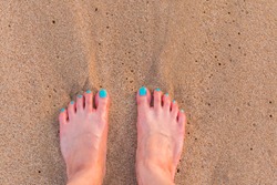 Shy Girl Feet Standing In Sand.a Wave comes in, as I stand and wait. copy space. top down view.Naked feet at the Beach - Barefeet nature Background.