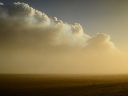 The smoke column of the 2014 Bardarbunga eruption at the Holuhraun volcanic fissures at sunset during a sandstorm in the otherworldy desert landscape of the Central Highlands, Iceland