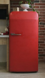 Red retro fridge with chrome handle in kitchen