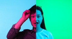 Wow, astonished. Collage of two halves of young people faces, man and woman over neon backgrounds. Concept of human emotions, facial expressions, mood.