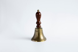 The old-style hand bell with a wooden handle and probably a brass body was used as a break bell in schools.