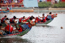 Scene of a competitive boat racing in the Dragon Boat Festival in Taipei, Taiwan, where the athletes pull vigorously on the oars & compete with all their strength in traditional colorful dragon boats