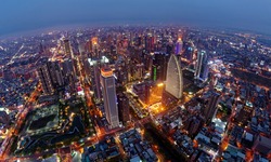 Aerial skyline of Downtown Taichung, the vibrant metropolis in central Taiwan, with modern skyscrapers towering in the 7th Redevelopment Zone and the city lights dazzling at blue dusk after sunset